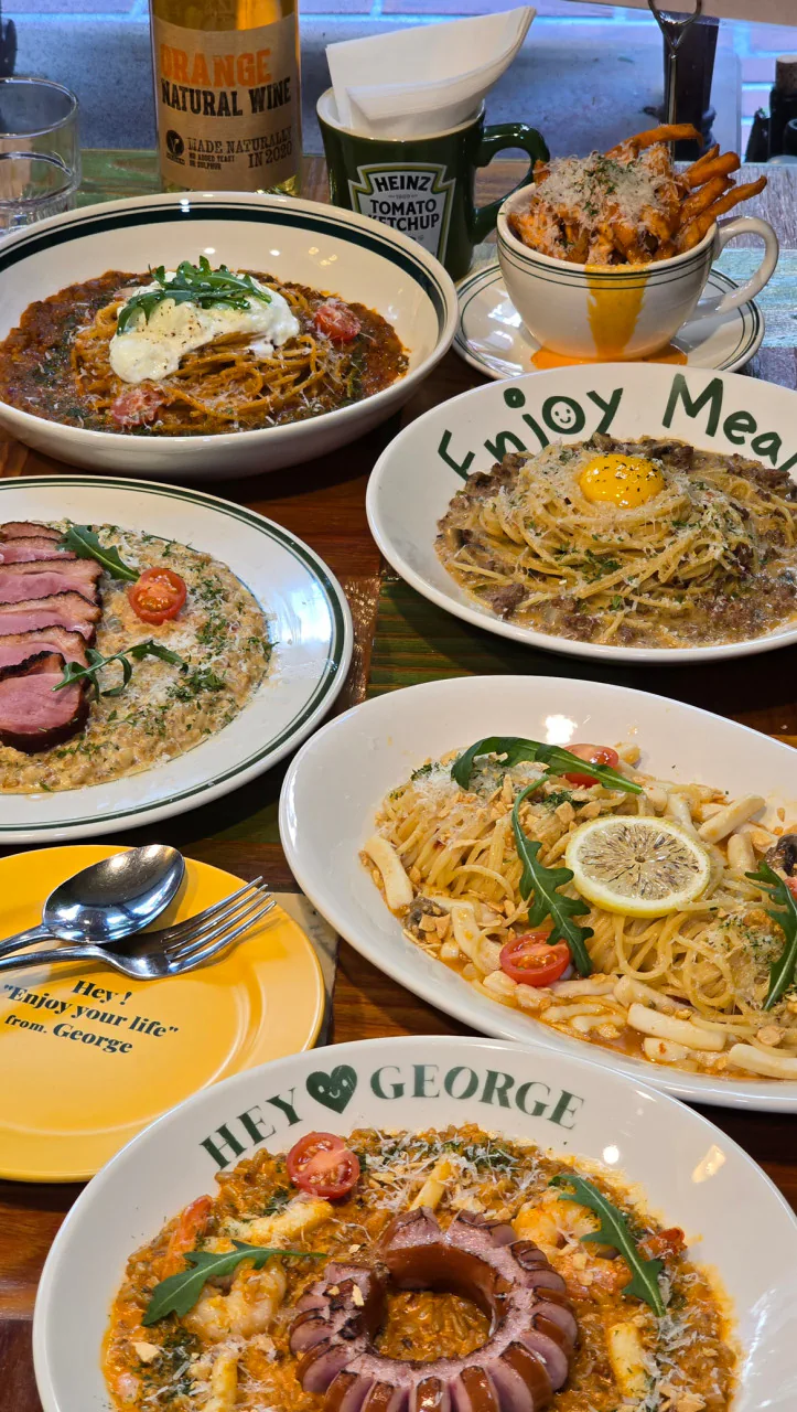 Pasta, risotto, and sliced steak served at Hey George