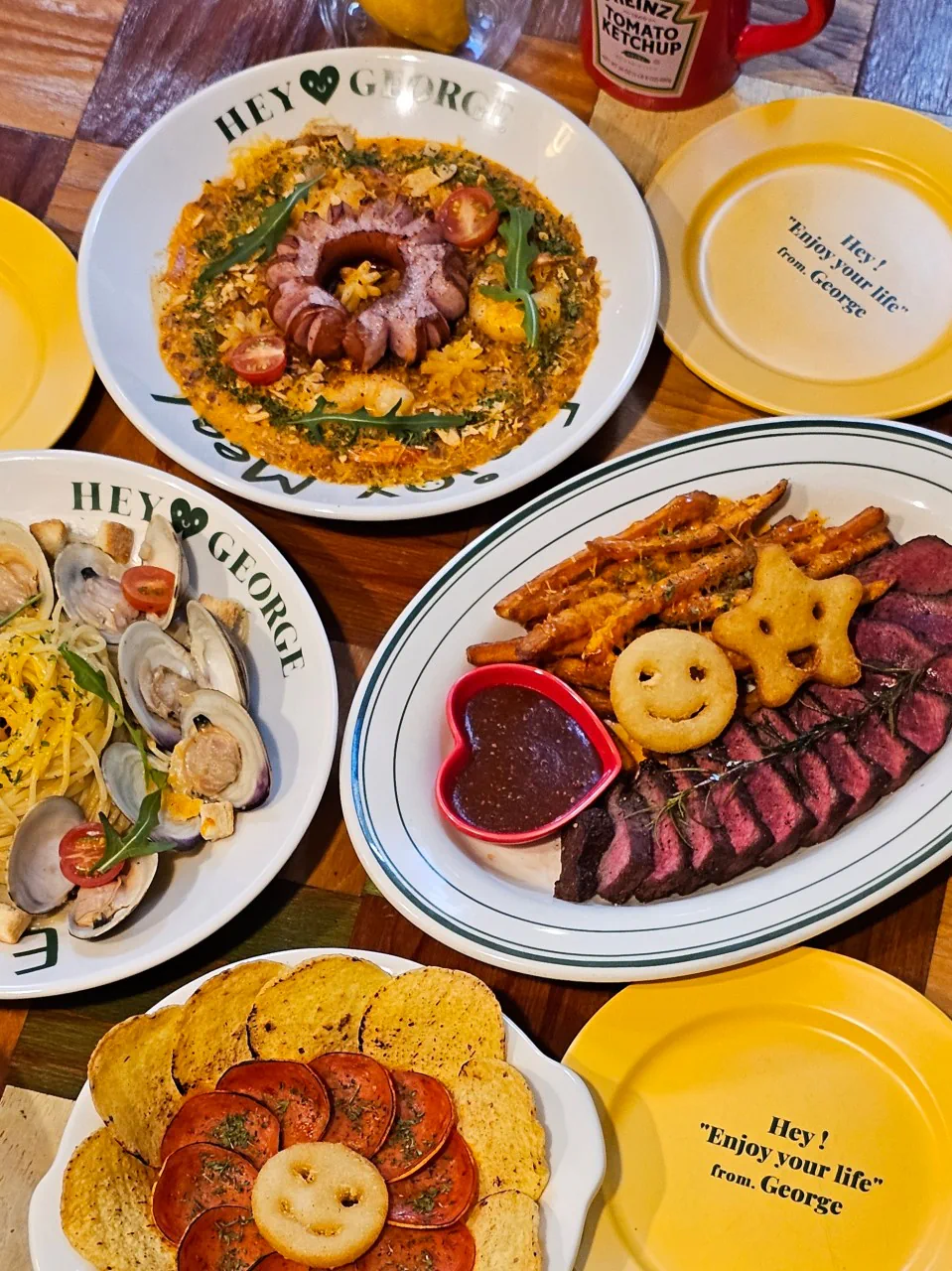 Overhead spread of several dishes at Hey George
